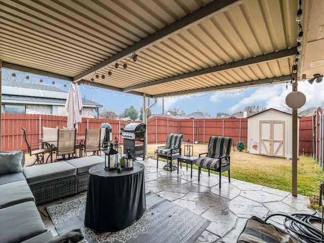 view of patio / terrace with an outdoor living space, grilling area, and a shed