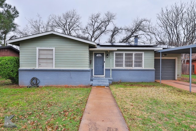 750 Peake St, Abilene, TX 79603 - view of front facade with brick siding, a front yard, a garage, and driveway