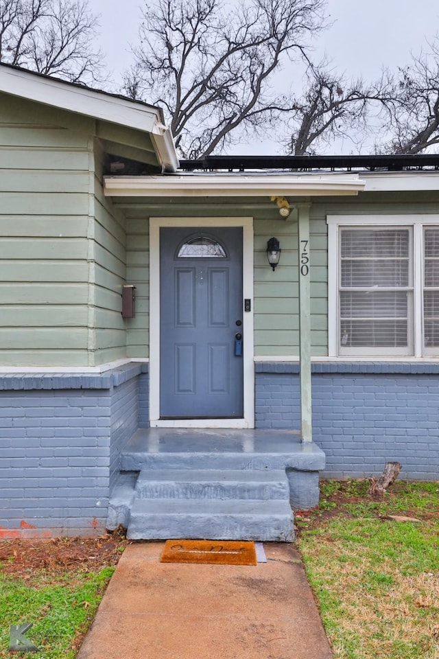 750 Peake St, Abilene, TX 79603 - doorway to property featuring brick siding