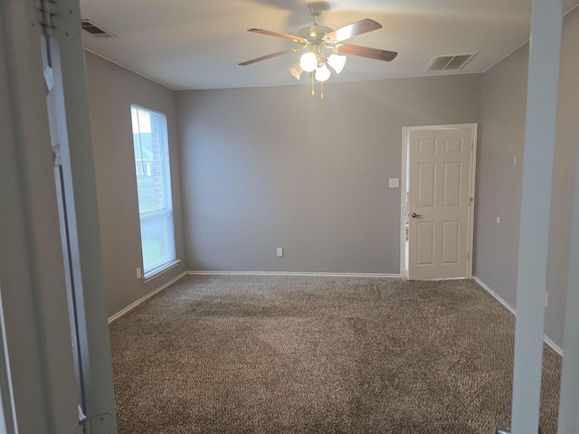 carpeted spare room with ceiling fan