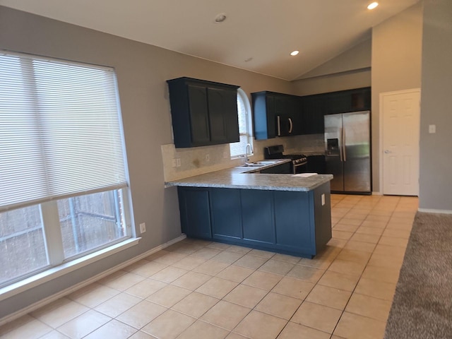 kitchen featuring lofted ceiling, sink, plenty of natural light, and appliances with stainless steel finishes