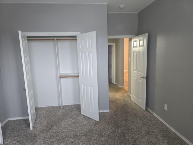 unfurnished bedroom with carpet and a closet