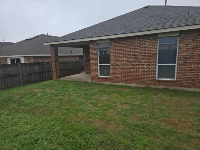 back of property with a patio area and a lawn