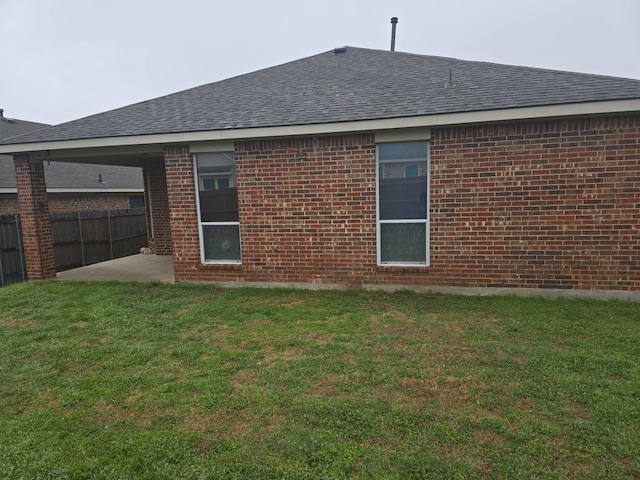 back of house with a yard and a patio area