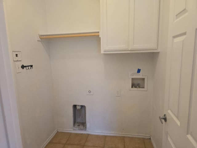 clothes washing area with hookup for a washing machine, hookup for an electric dryer, cabinets, and light tile patterned floors