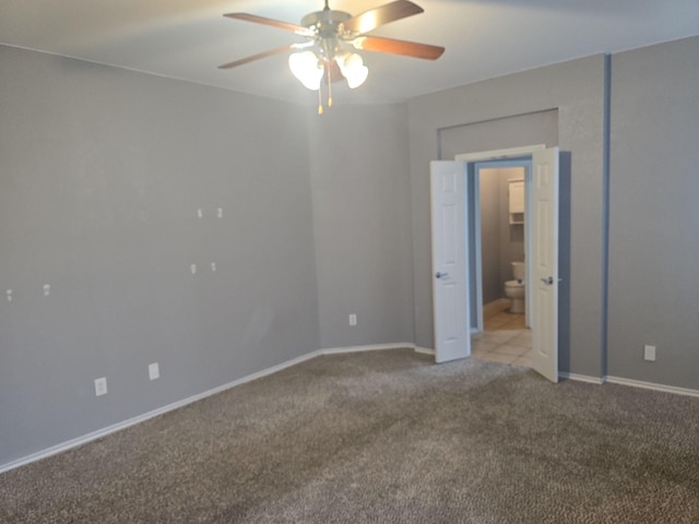 unfurnished bedroom featuring ceiling fan, connected bathroom, and light carpet