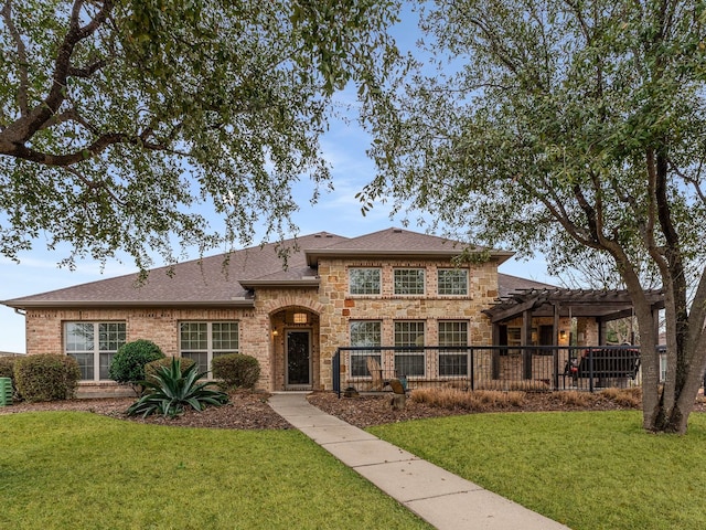 view of front of house with a pergola and a front lawn