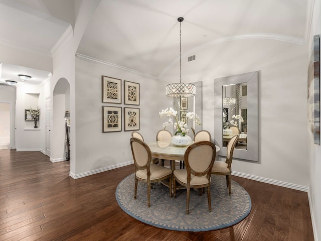 dining area featuring lofted ceiling, crown molding, and dark hardwood / wood-style floors