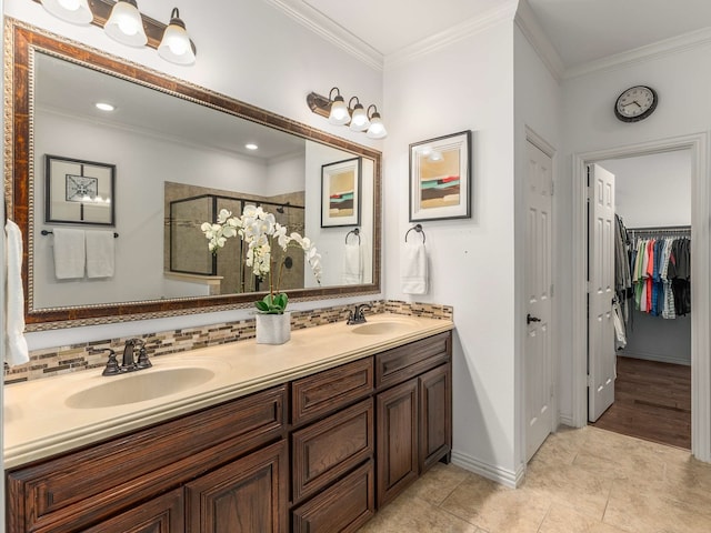 bathroom with vanity, a shower with shower door, ornamental molding, and tasteful backsplash