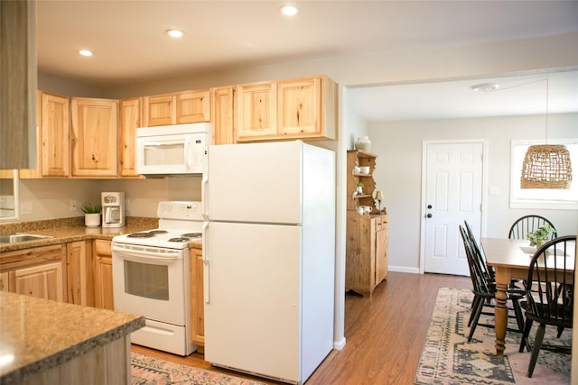 kitchen featuring light brown cabinetry, decorative light fixtures, sink, hardwood / wood-style flooring, and white appliances