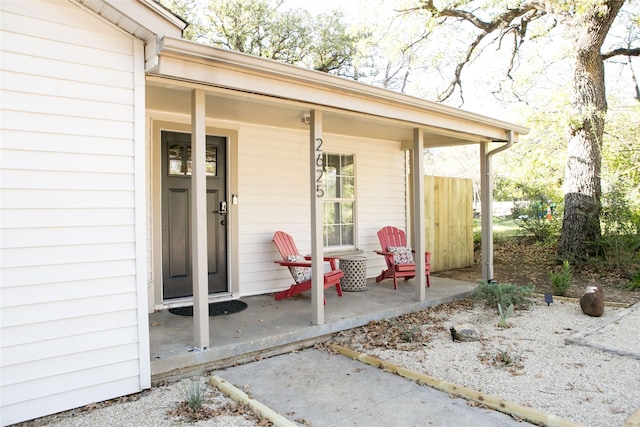 view of exterior entry featuring covered porch