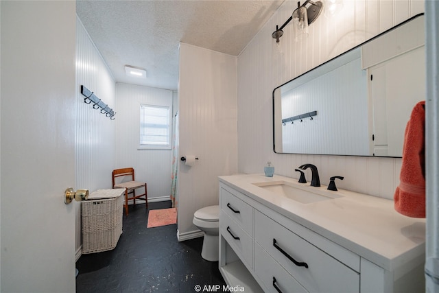 bathroom featuring vanity, concrete flooring, toilet, and a textured ceiling