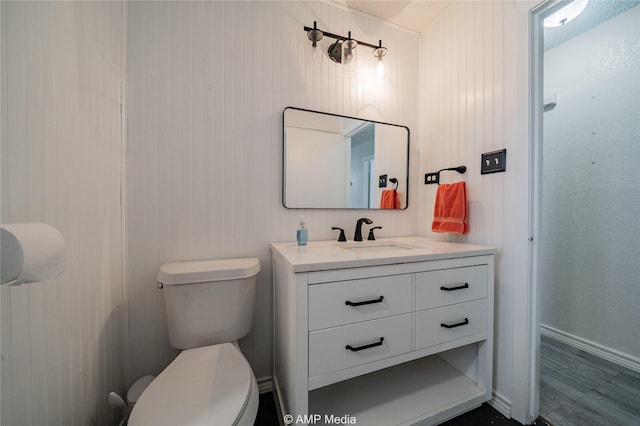 bathroom with vanity, hardwood / wood-style flooring, and toilet