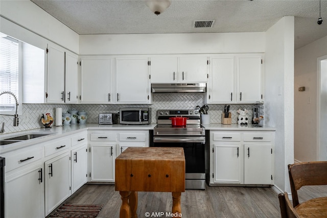 kitchen featuring white cabinetry, sink, light hardwood / wood-style flooring, and stainless steel appliances