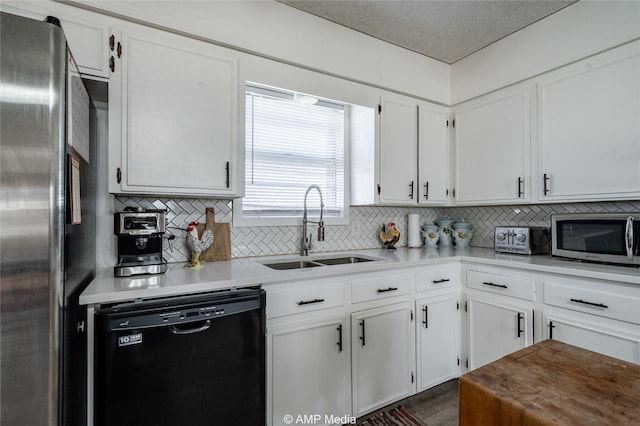 kitchen featuring white cabinetry, sink, tasteful backsplash, and appliances with stainless steel finishes