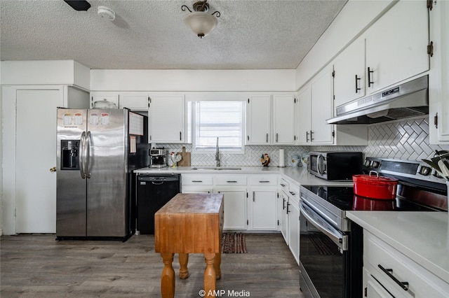 kitchen featuring white cabinetry, appliances with stainless steel finishes, sink, and dark hardwood / wood-style floors