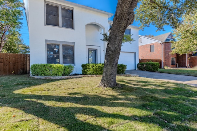 view of front facade with a garage and a front lawn