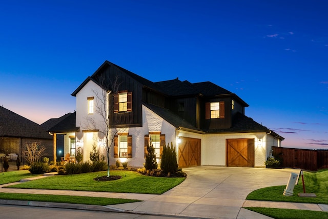 view of front of property with a garage and a yard