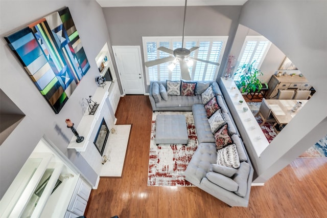 living room featuring hardwood / wood-style floors and ceiling fan