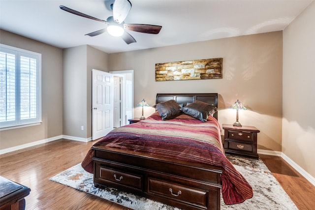 bedroom with light hardwood / wood-style floors and ceiling fan