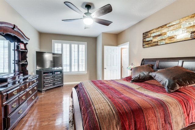 bedroom with hardwood / wood-style floors and ceiling fan