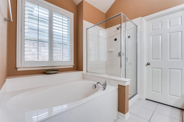 bathroom featuring tile patterned flooring, lofted ceiling, and shower with separate bathtub