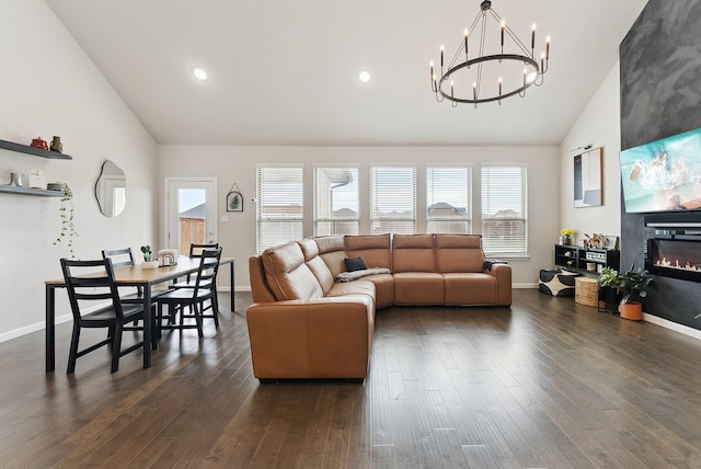 living area featuring recessed lighting, dark wood-type flooring, a glass covered fireplace, high vaulted ceiling, and baseboards