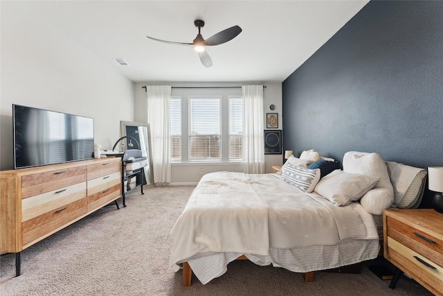 bedroom with carpet floors, visible vents, and a ceiling fan