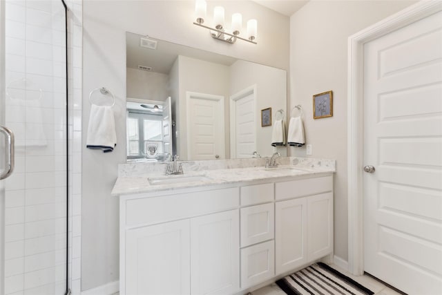 full bathroom featuring double vanity, a sink, visible vents, and a shower stall