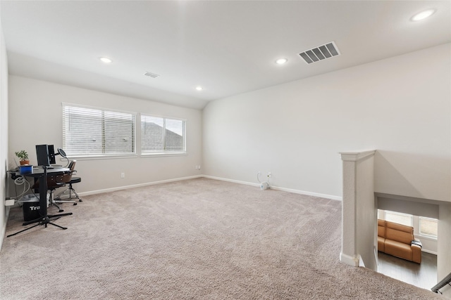 office space featuring light carpet, baseboards, and visible vents