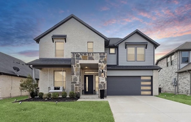 view of front of home with a front lawn, an attached garage, brick siding, and driveway