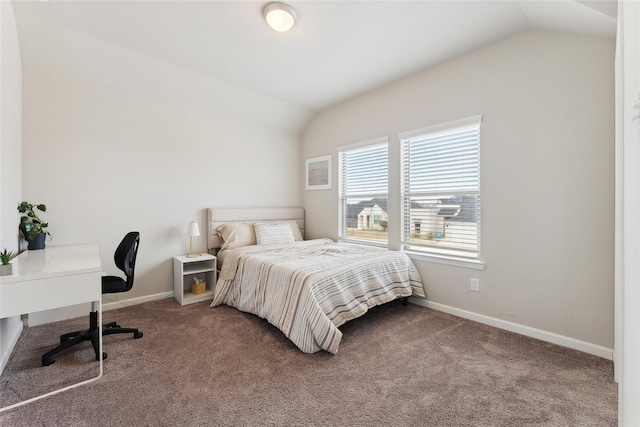 carpeted bedroom with vaulted ceiling and baseboards