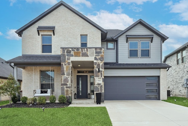 view of front of home featuring a garage, driveway, brick siding, and roof with shingles