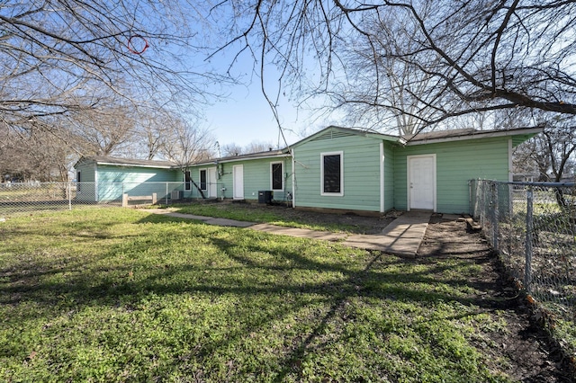 rear view of house featuring central AC unit and a yard