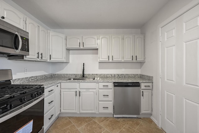 kitchen with white cabinetry, sink, and stainless steel appliances