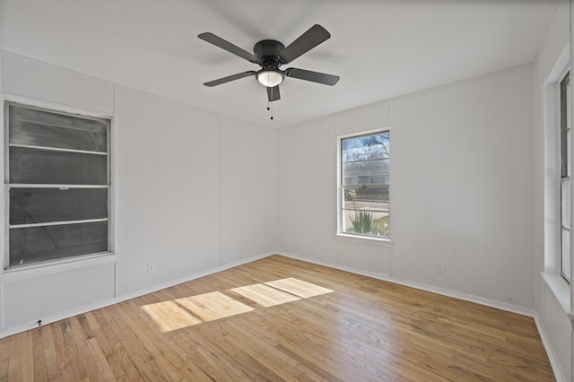 spare room with hardwood / wood-style flooring and ceiling fan