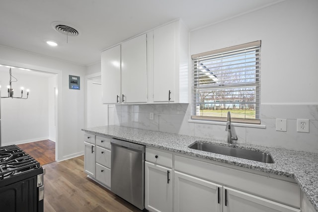 kitchen featuring sink, white cabinetry, light stone counters, gas range oven, and stainless steel dishwasher