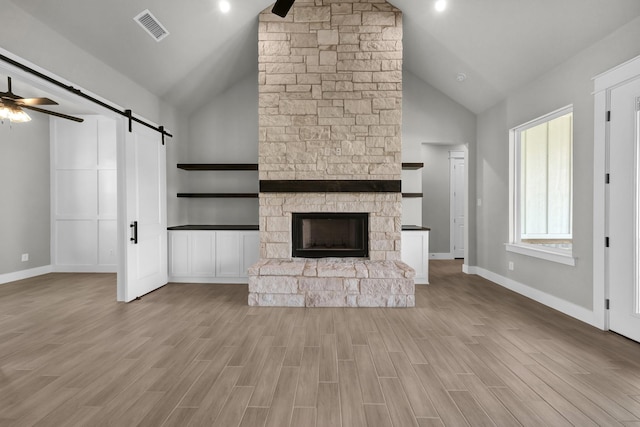 422 Collum Vw, Azle, TX 76020 - unfurnished living room with a barn door, high vaulted ceiling, ceiling fan, wood finished floors, and baseboards