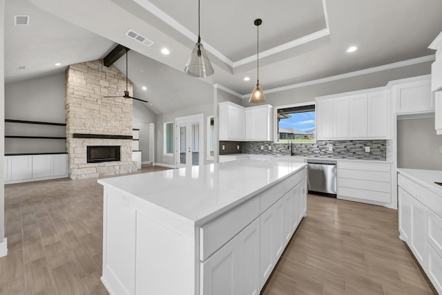 422 Collum Vw, Azle, TX 76020 - kitchen with dishwasher, tasteful backsplash, a ceiling fan, a fireplace, and white cabinets
