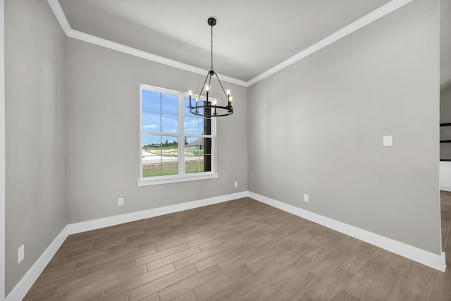 422 Collum Vw, Azle, TX 76020 - spare room featuring a chandelier, ornamental molding, wood finished floors, and baseboards