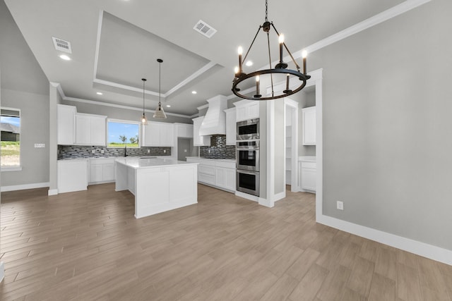 422 Collum Vw, Azle, TX 76020 - kitchen featuring a raised ceiling, crown molding, appliances with stainless steel finishes, tasteful backsplash, and a chandelier