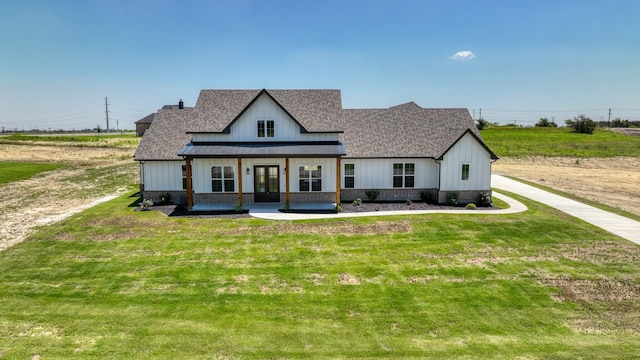 modern farmhouse style home with a front lawn, a shingled roof, a standing seam roof, and metal roof