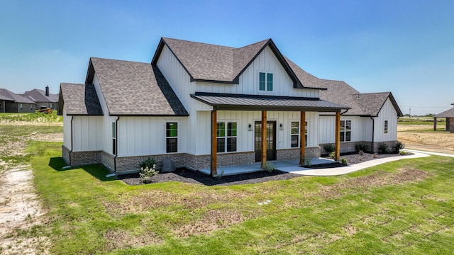 422 Collum Vw, Azle, TX 76020 - view of front of property featuring french doors, roof with shingles, board and batten siding, a front lawn, and brick siding