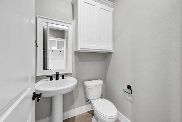 422 Collum Vw, Azle, TX 76020 - bathroom featuring toilet, baseboards, and wood finished floors