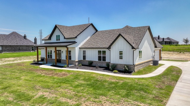 modern inspired farmhouse with a front lawn, roof with shingles, board and batten siding, and brick siding