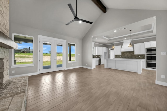 422 Collum Vw, Azle, TX 76020 - unfurnished living room with ceiling fan, beamed ceiling, baseboards, french doors, and light wood-style floors
