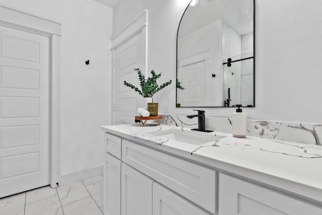 bathroom with a shower with door and vanity