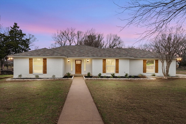 single story home featuring a yard