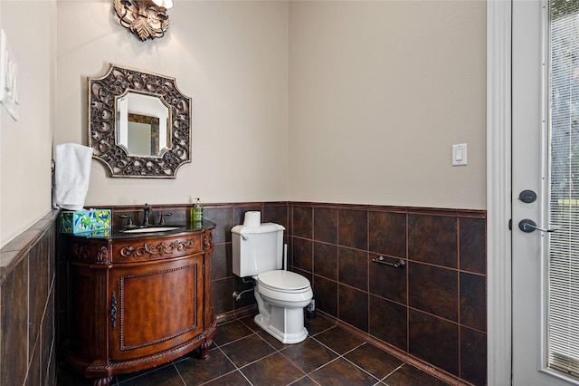 105 Zephyr Ct, Aurora, TX 76078 - bathroom featuring toilet, tile walls, tile patterned floors, vanity, and wainscoting