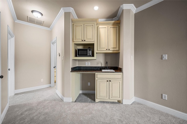 105 Zephyr Ct, Aurora, TX 76078 - kitchen featuring cream cabinets, light colored carpet, ornamental molding, a sink, and visible vents